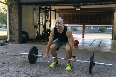 muscular man exercising at home in the driveway