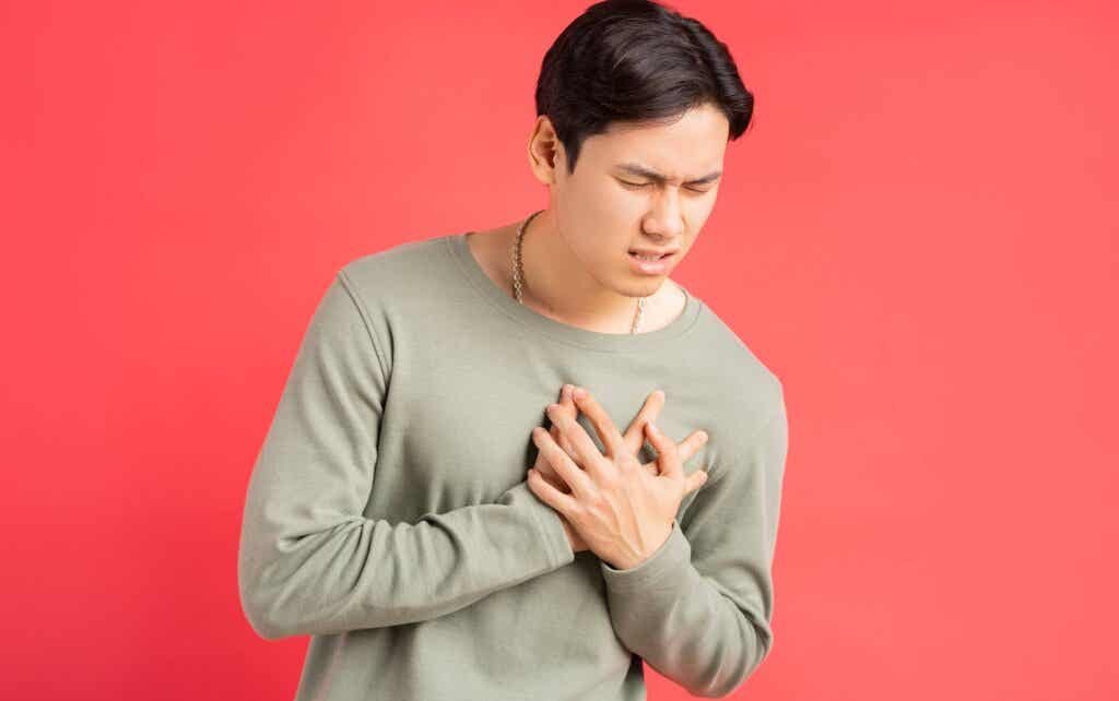 A man placing his hands over his heart when exhibiting symptoms of somatic OCD.