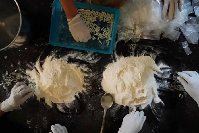 Sinaloa Cartel members prepare meth capsules in a safe house in Culiacan, Mexico