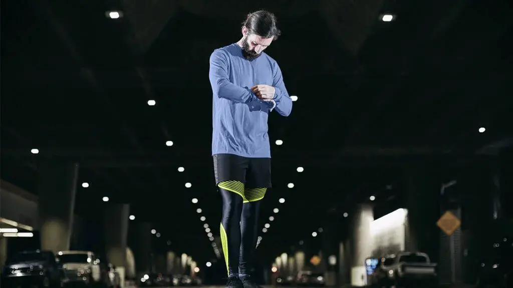 bearded man in sportswear checking his smartwatch