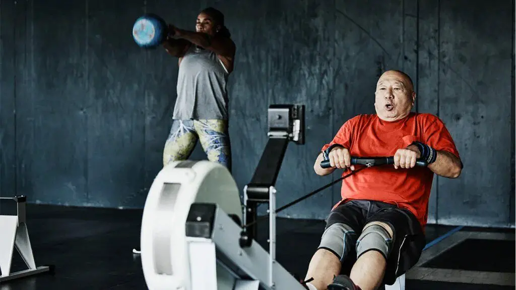 A woman and a man exercise in the gym