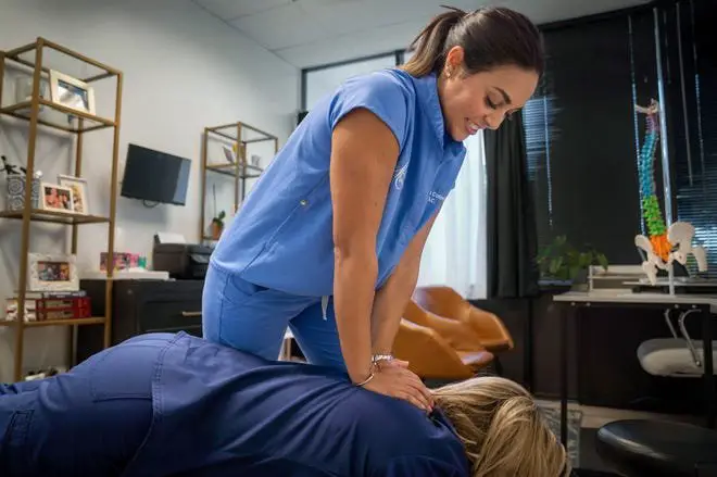 Chiropractor Dr. Alessandra Colon adjusts Doreen Murphy who works with her at Papa Chiropractic and Physical Therapy in Palm Beach Gardens, Florida on July 13, 2023. Colon stars in the television show