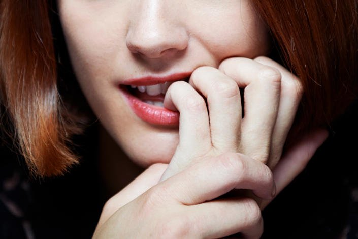 woman biting her nails (Tara Moore/Getty Images)